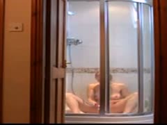 A beautiful wife is seen masturbating while taking a shower on camera.